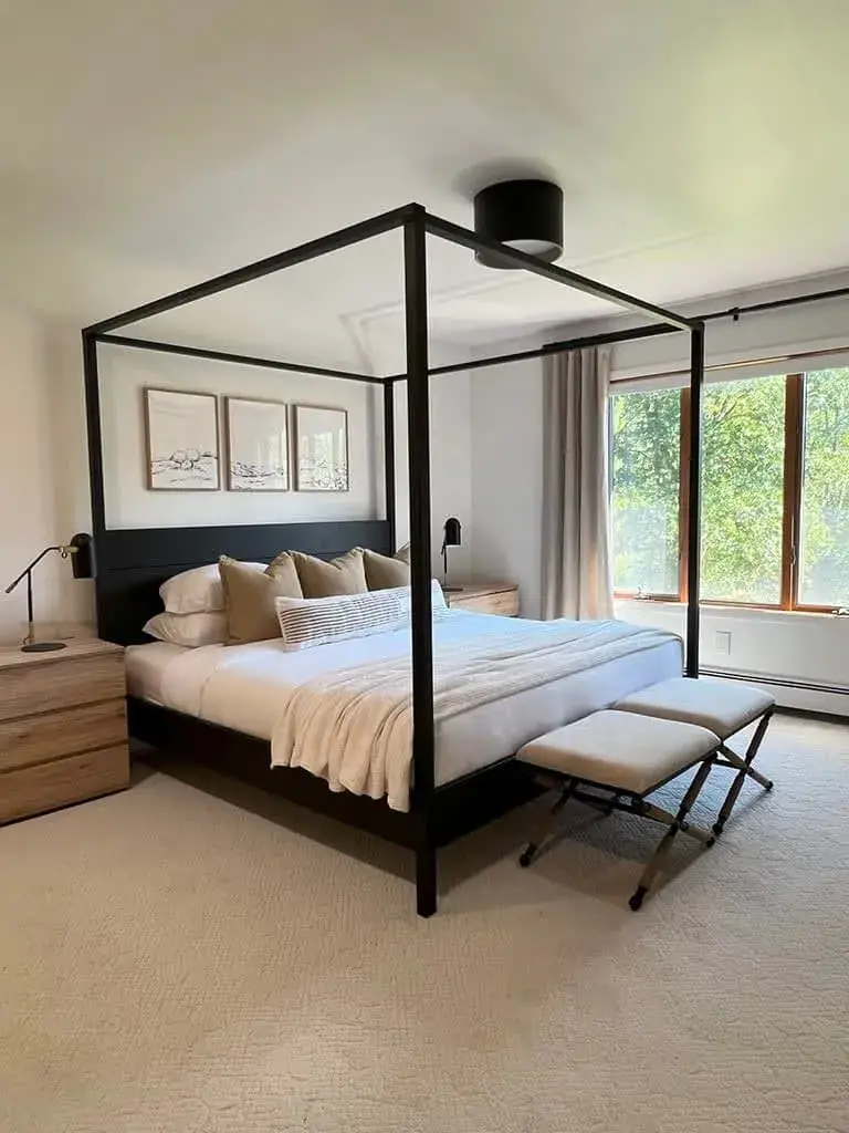 The primary bedroom: a king canopy bed with windows on two sides