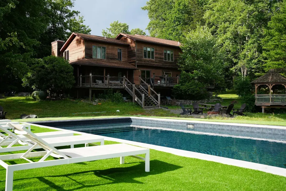 The house and gazebo seen across the pool