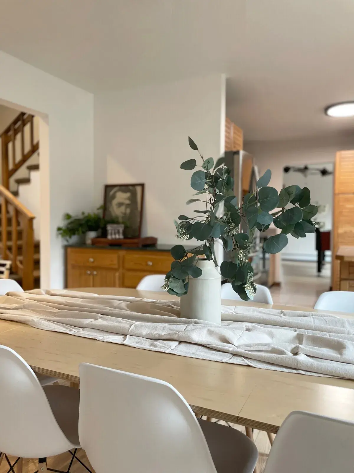The dining table, the stair beyond