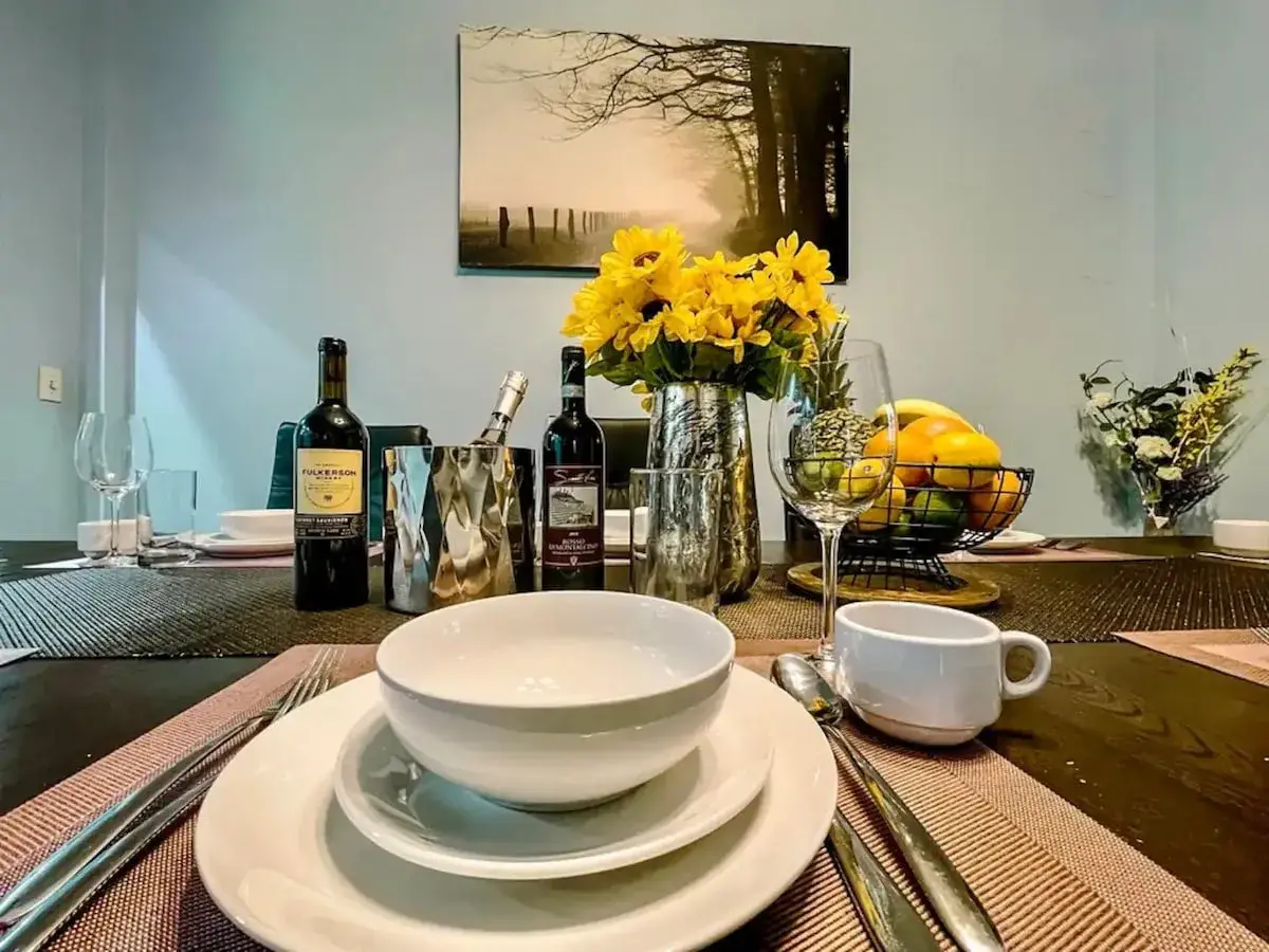 A table set with wine, flowers and fruit