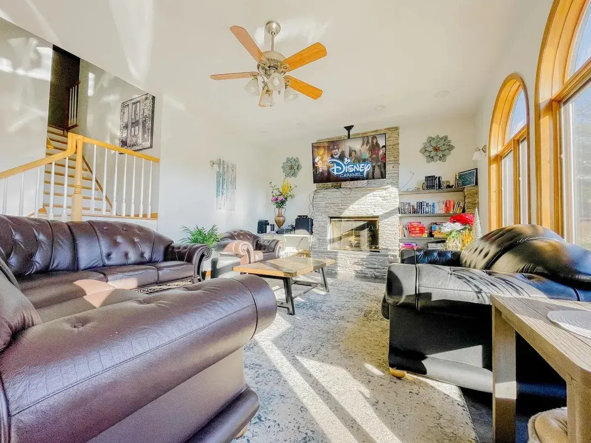 The family room, leather sofas around a fireplace