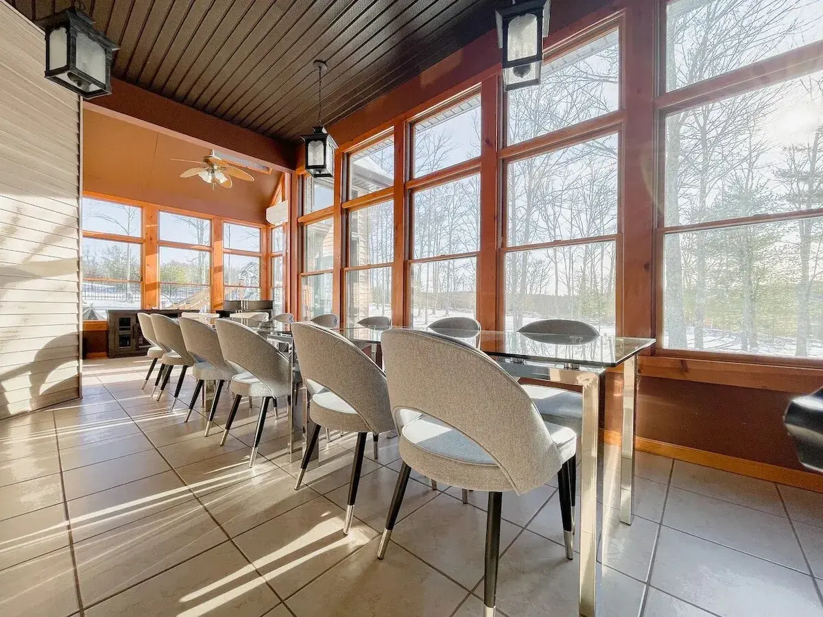 The sunroom dining table, windows on three sides