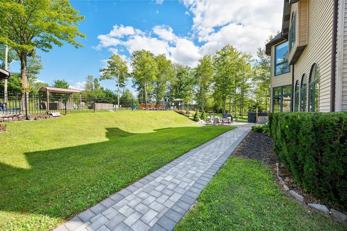 A paved path along the side of the house