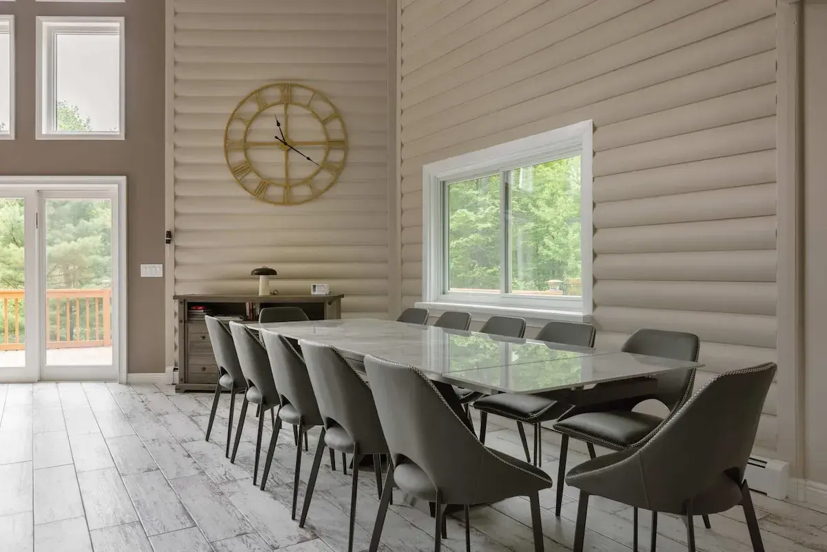 The dining table beneath the wall clock