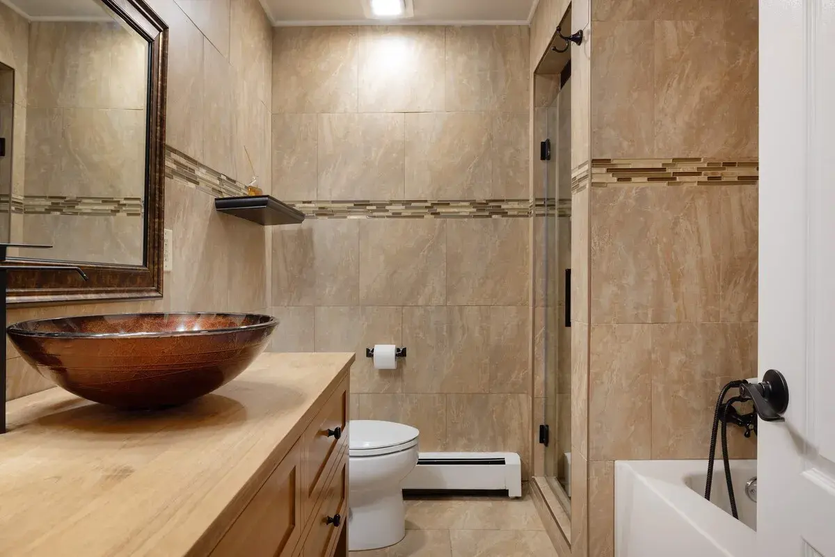 A bathroom with a copper vessel sink